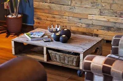 a wooden coffee table with vases on top of it at Modern Shabby Chic Apartment in Durbanville