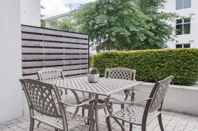 a white table and chairs on a patio at Lux Andringa Walk Apartments in Stellenbosch