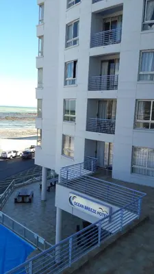 a building with a sign that reads ocean reef hotel at Sunset 786 Holiday Accommodation Unit-207 in Strand