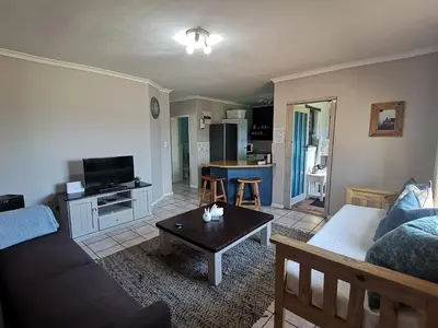 a living room with a couch and a table at Villa De Vie Self Catering Apartment in Brackenfell
