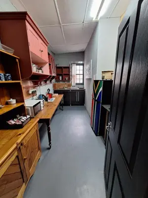 a large kitchen with a long table in a room at De Oude Schuur in Stellenbosch