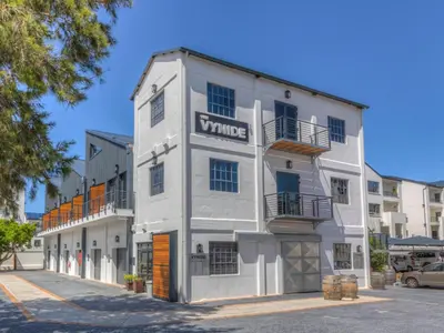 a white building with a vulture sign on it at Crossfire @ Home in Somerset West
