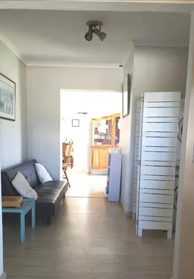 a living room with a couch and a table at Da Capo in Bettyʼs Bay