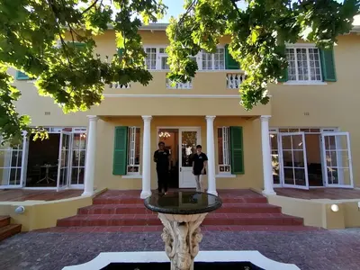 two police officers standing in front of a building at De Haas Luxury Living at Villa Grande in Stellenbosch