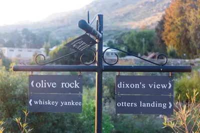 a street sign with directional signs on a pole at White Bridge Farm Accommodation in Wolseley