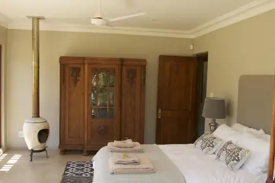 a bedroom with a bed with two towels on it at The Riverstone House in Romansrivier