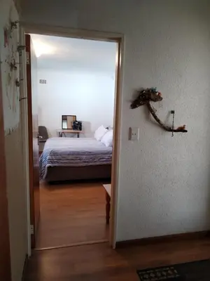 a bedroom with a bed and a door to a room at 34 On Marten Crescent in Table View