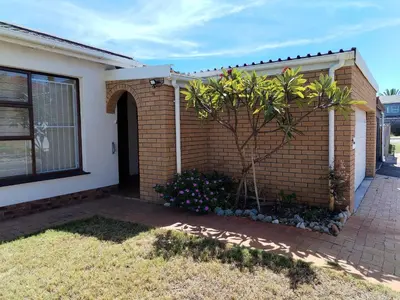 a brick house with a tree in a garden at 34 On Marten Crescent in Table View