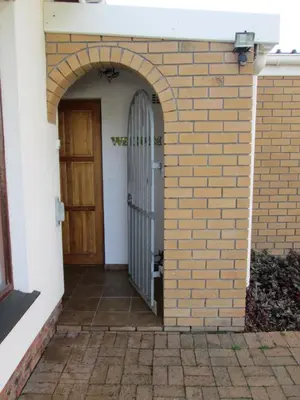 an entrance to a brick building with a door at 34 On Marten Crescent in Table View