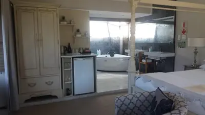 a room with a bathroom with a tub and a sink at Slaley Country House in Stellenbosch