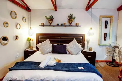 a bedroom with a bed with a dog laying on it at Strand Guesthouse in Strand