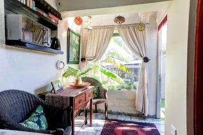 a living room with a table and a window at Strand Guesthouse in Strand