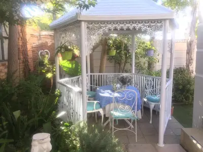 a white gazebo with a table and chairs at Marshrose Accommodation in Bellville