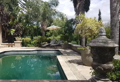 a swimming pool with a fountain in a yard at 35 on Basil in Caledon