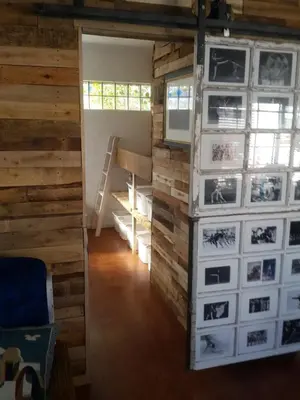a room with a wall of pictures on the wall at Dancers' Cottages in Cape Town