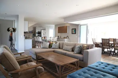 a living room with a couch and a table at Cape Coral in Hermanus