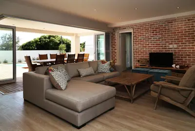 a living room with a couch and a table at Cape Coral in Hermanus