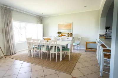 a kitchen and dining room with a table and chairs at On The Rocks in Hermanus