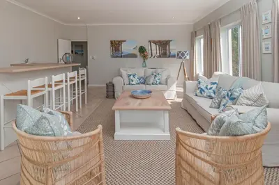 a living room with a couch and a table at On The Rocks in Hermanus