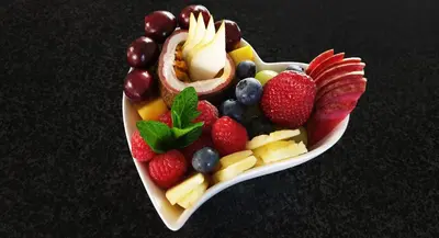 a plate of fruit and vegetables on a table at Villa Adalbert Guesthouse in Somerset West
