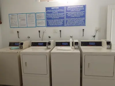 a row of washers and dryers in a room at Beach front property in Strand