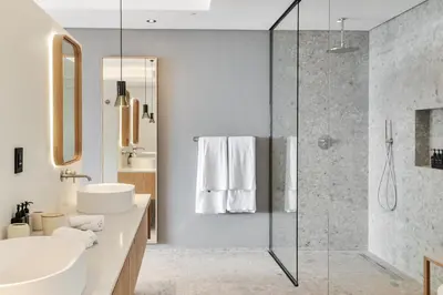 a bathroom with a sink and a glass shower at Clouds Estate in Stellenbosch