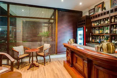a restaurant with a bar with a table and chairs at Protea Hotel by Marriott Dorpshuis & Spa Stellenbosch in Stellenbosch