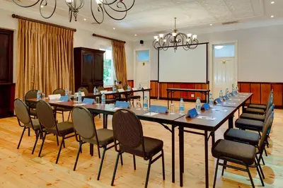 a large conference room with a long table and chairs at Protea Hotel by Marriott Dorpshuis & Spa Stellenbosch in Stellenbosch
