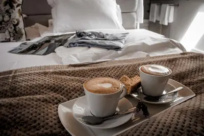 two cups of coffee on a tray on a bed at Andreas Country House in Wellington