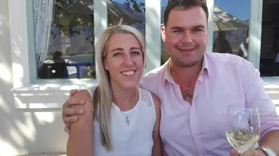 a man and a woman holding a glass of wine at Two Vines Romantic Guest Studio in Stellenbosch