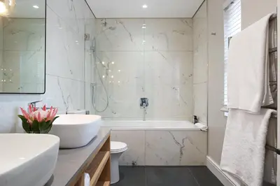a bathroom with a tub and a sink and a toilet at Bonne Esperance Boutique Guest House in Stellenbosch