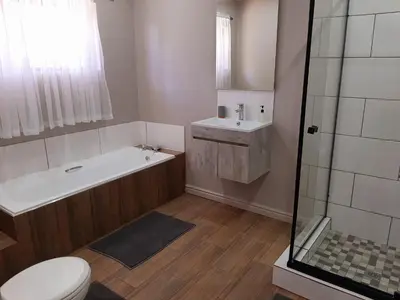 a bathroom with a tub and a toilet and a sink at Panorama Self Catering in Panorama