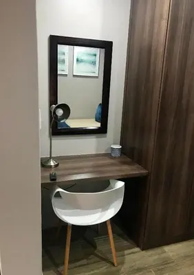 a mirror and a white chair in a room at Panorama Self Catering in Panorama