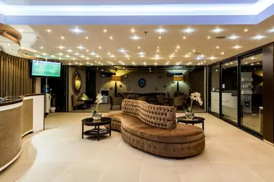 a large living room with a couch and tables at Aquarius Luxury Suites in Bloubergstrand