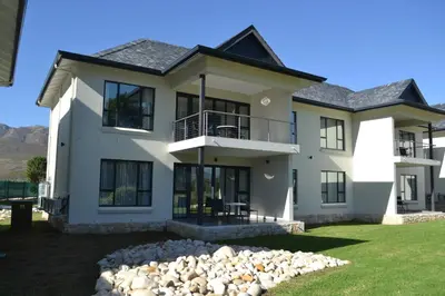 a large white house with a lot of windows at Pearl Valley Suites in Simondium