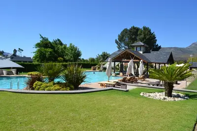 a resort with a pool and a gazebo at Pearl Valley Suites in Simondium