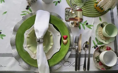 a table with a green plate with a fork and knife at Centre-Ville Guest House in Franschhoek
