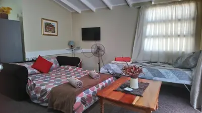 a living room with a couch and a table at Welterusten Guesthouse in Strand