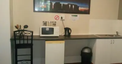 a kitchen with a counter with a microwave and a sink at Glen Lilly Self Catering in Parow