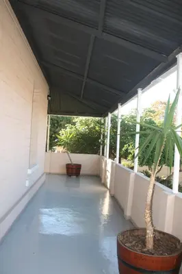 a porch with a potted plant in a pot at Glen Lilly Self Catering in Parow