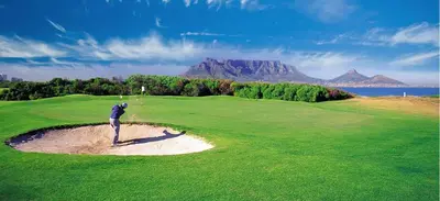a man is playing golf on a golf course at Milnerton Guesthouse in Cape Town