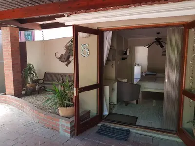 an open door of a house with a living room at The Fairway in Cape Town