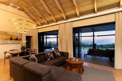 a living room with a couch and a piano at Kunjani Villas & Wines in Stellenbosch