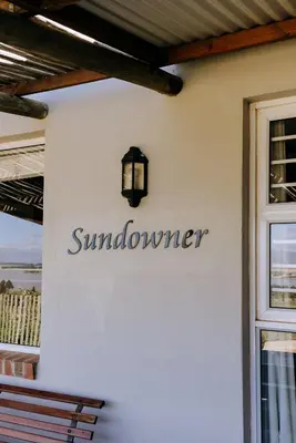 a sign on the side of a building at Dennehof Farm Guesthouse in Villiersdorp