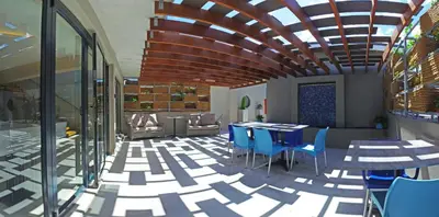 a restaurant with blue chairs and tables and a ceiling at 7 on Marine in Hermanus