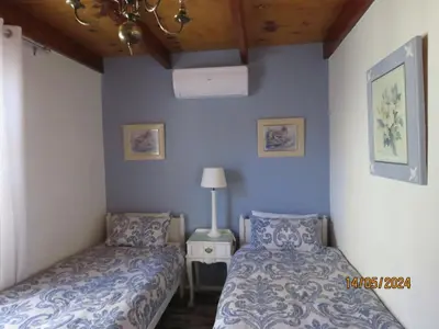 a bedroom with two beds and a lamp on a table at Town and Country in Caledon