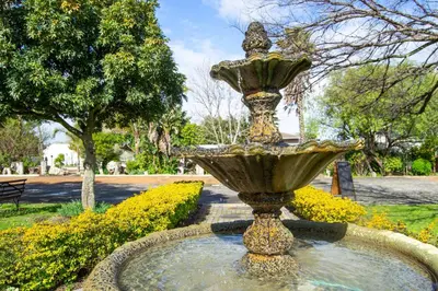 a fountain in the middle of a park at Ruslamere Hotel and Conference Centre in Durbanville
