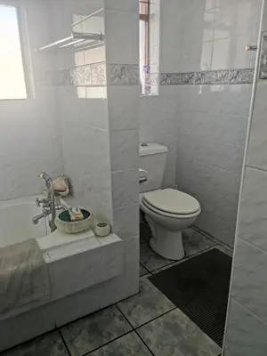 a white bathroom with a toilet and a sink at Eikepark Self Catering in Stellenbosch