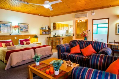 a living room with a bed and a couch at Eikepark Self Catering in Stellenbosch