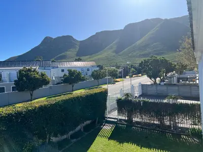 a view of a street with mountains in the background at Oude Schuur Boutique Guesthouse in Hermanus